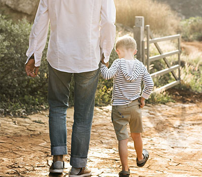 agri-tourism - boy and man walk on the farm