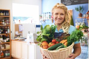 farm shop worker holding basket of produce