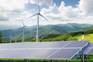 energy production - a mountainside with wind turbine and solar panels