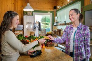 customer purchasing fruit and veg from farm shop